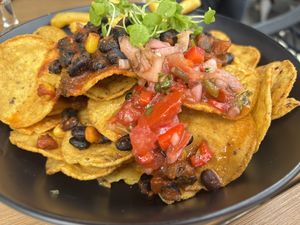 Loaded nachos (few chips added at the back!) it also came with jalapeños   at Waterside Restaurant and Bar in Taupo