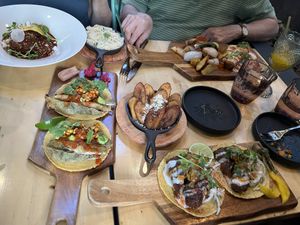 Chicken Mole (top left), Banana Blossoms (middle left), Platanos Maduros (center), Papas con Chorizo (top right), Spicy Chorizo (bottom right)  at Sentir in New York City