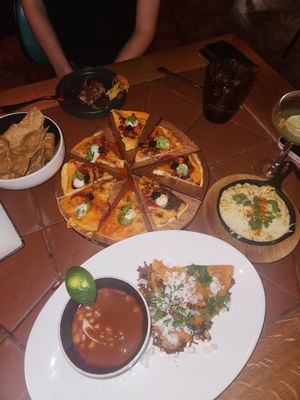 Chicken quesadillas, creamed corn, and birria tacos at Sentir in New York City