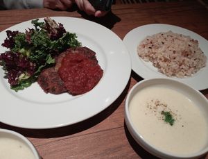 The lotus root hamburger steak dinner set (with a tomato sauce, rice, potato potage and a not-pictured soft drink) at Vegan Eat Tokyo in Tokyo
