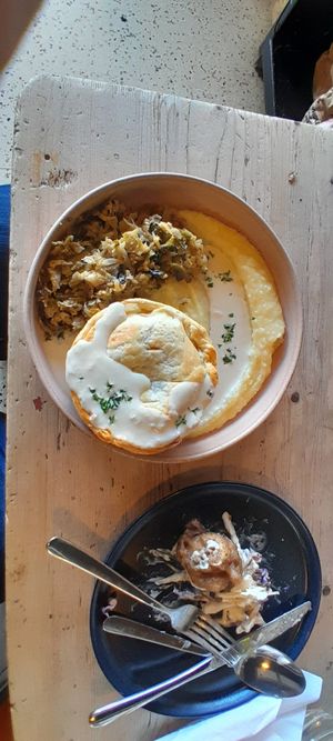 Celeriac and leek pie with divine creamy mash and herby sauce, next to the remnants of a lemon battered cauliflower bite. at The Kitchen @ Brixton Yoga in Leamington Spa