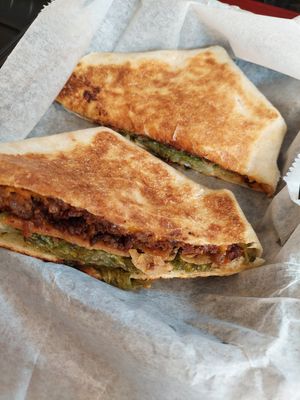 Crunch wrap with burger filling and collards at Clean Plates Café & Juice bar  in Reading