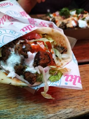 Souvlaki with chilli sauce and feta, with souvlaki snack pack in the background at I Should be Souvlaki Canteen   in Brunswick