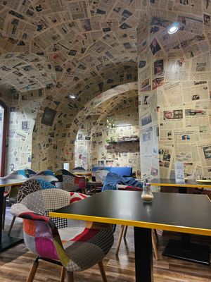 The wallpaper is made out of real newspapers 😯 at Café Localité in Brno