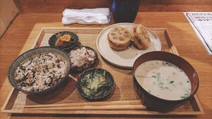 White miso soup, rice, vegetables with various sauces and fried lotus root with mushroom. at Hug Kitchen in Tokyo