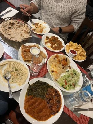 Houmous, pumpkin bolanee, spinach, pumpkin, kidney beans and aubergine curries, bread and water  at Ariana 2 in North West London