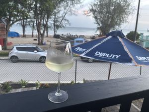 Glass of wine with a beautiful view!  at Casper's Beachside  in Oistins