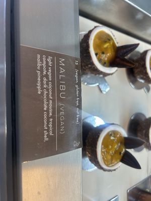 So good - I thought passionfruit but apparently “Malibu pineapple” - regardless dark chocolate shell with coconut mousse and the tropical filling was so delicious!   at Origami - Napier in Napier