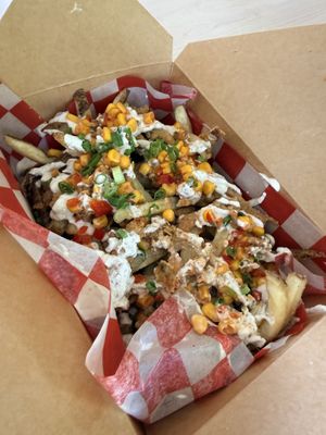 Loaded Vegan fries with Vegan garlic aioli and corn salsa.    at The Roti Den in Bridgetown