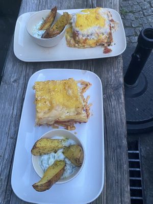 Moussaka and noodle dish,  potato wedges and tzatziki   at The Crazy Little Greek in Berlin