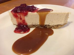 Cashew cheesecake  with salted caramel and raspberry sauce - YUM! at Sealevel City Vegan Diner in Wilmington