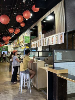 Bar seating, or more tables at back of food court  at Oh! Dahon in New York City