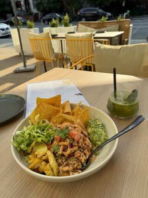 Al pastor bowl and Herb Your Enthusiasm cocktail in the outdoor seating area    at PLANTA Cocina in Washington