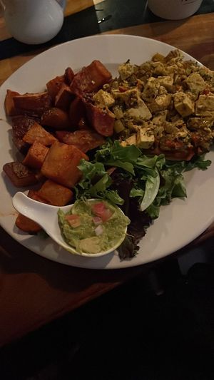 Tofu rancheros with guacamole and tortilla under the curried tofu at Insomnia Restaurant Bar Lounge in Toronto