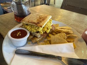 Potato bread stack with sausages, scrambled tofu and bacon  at Hustle in Belfast