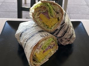 WRAP FILLED WITH VEGAN PUMPKIN SEED EGG, LETTUCE, RED CABBAGE, ONIONS, TOMATOES, CASHEW GARLIC SAUCE  at inner you vegan in Tenerife