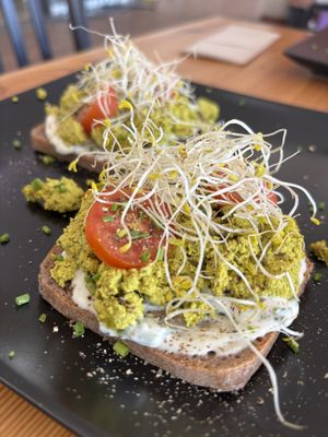 Homemade pumpkin seed egg with chive cheesy sauce on rye bread   at inner you vegan in Tenerife