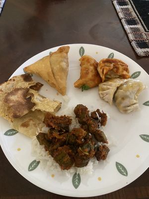 We got it to go (most packaging is compostable!) so here is some roti, a samosa, chili and regular momo and some bhindi masala  at Gurkhas in Longmont