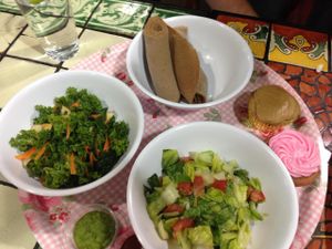 Side plate has: Strawberry cupcake (gf), Carmel cupcake (gf), Timatam salad, Shimbra salad & gf injera at Azla Vegan in Los Angeles
