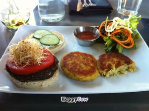 Mushroom quinoa burger on a gluten free bun with salad and chickpea polenta. at enVie A Vegan Kitchen in Halifax
