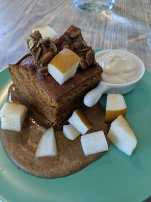 Warm Gingerbread dessert: gingerbread cake, rum sauce, fresh pear, pumpkin brittle, coconut whip at enVie A Vegan Kitchen in Halifax