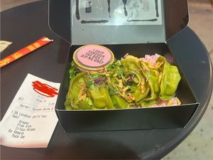 Veggie dumplings on greens and pink rice, topped with fried onions  at Lovebite in Phoenix