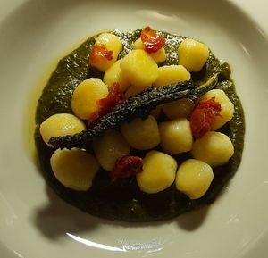 Potato gnocchi with black kale and almond pesto and dried tomatoes at Settecentoalberi in Noventa Di Piave
