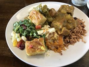 Vegan buffet items: “chicken” curry, Salad, collards, peas and rice, sweet potato casserole, corn bread  at Mango's Caribbean Cookhouse in Huntsville