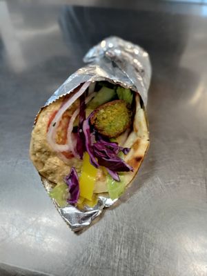 Falafel or vegan nuggets wrap with lettuce , tomato , onions , banana peppers , and your choice of sauce (hummus or eggplant) wrapped in a homemade pita bread!! at Eat Like A Greek  in Edgewood
