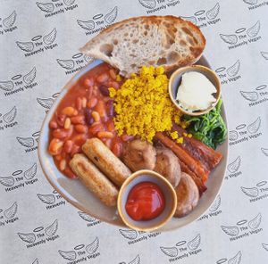 Looking for something delicious, satisfying, and completely plant-based? featuring, Scrambled tofu eggs, Beans, Spinach, Sausage, Bac'n, Mushroom and Sourdough toast. at Heavenly Vegan Coffi in Barry
