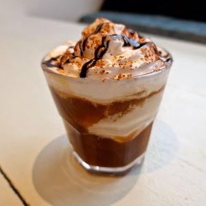 Say hello to your new favourite guilty pleasure: glace coffee. Made with the perfect mix of espresso, creamy vanilla ice cream, and a generous drizzle of chocolate sauce topping. at Heavenly Vegan Coffi in Barry