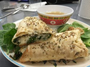 @vegetarian plus shrimp@followyourheart mozzeralla cheese with kale, spinach and grilled onions baked wrap with @followyourheart ginger miso dressing! at Vegan Take Out Plus in Tampa