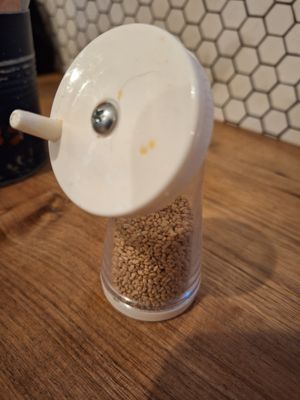 Sesame seeds on the tables to add to ramen at Umamido - Honest Ramen in Brussels