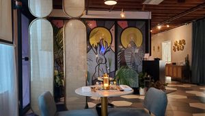 Decor and anime movie on left wall at Sushi Saint in Orlando