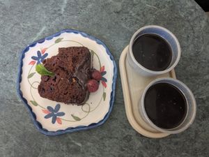 Slice of vegan cherry and chocolate cake with two Americanos at karaffu | coffee culture in Innsbruck