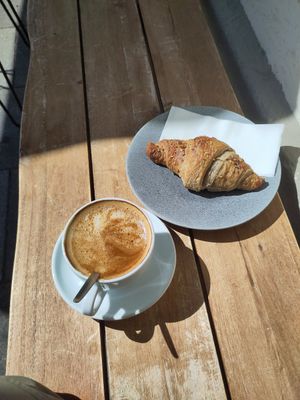 Flat white and a filled croissant at etisch. in Munich