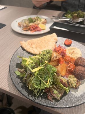 Plantmore signature plate with falafel. Avo toast in the background. All tasty!  at plant more in Tokyo