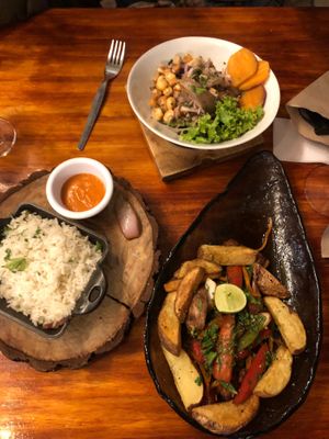 Ceviche and the unpleasantly salty lomo saltado that was served with rice on a different plate for some reason.  at Green Point in Cusco
