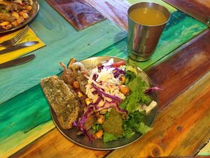 Salad buffet with lettuce, cabbage, corn, bread, tomato, pasta, zucchini and eggplant’s rings and 3 types of sauce. Passionflower juice.  at Green Point in Cusco