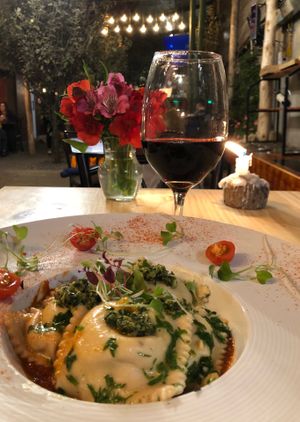 The pasta stuffed with mushrooms, on a rustic tomato sauce topped with pesto. My favourite!! The Spanish red was likewise amazing. A great pair! at Green Point in Cusco