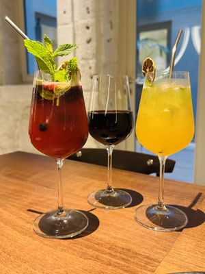 Strawberry sangria, red wine, and passion fruit spritz mocktail  at roots in Porto