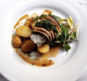 Beautiful potatoes with eggplant roll filled with créme fraiche cheese and side salad. at Estrella in Prague
