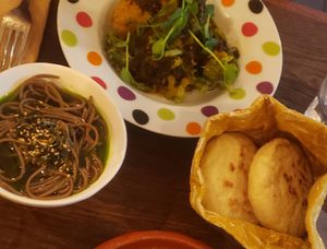 Main dishes served with tasty udon and batbout bread at La Cuisine de Souad in Pantin