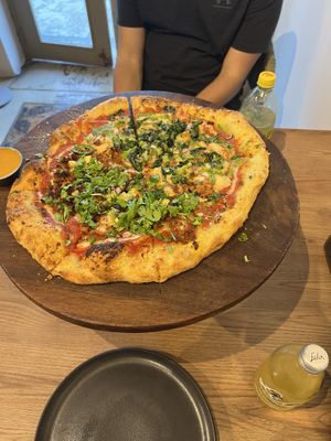 One side with “chorizo” pineapple and jalapeño, the other with “chicken” pesto   at Marcello's Plant Based Pizza in Cabo San Lucas