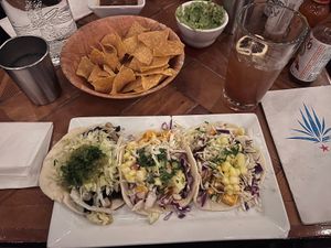 Sweet potato black bean taco and siracha honey tofu taco, plus chips and guacamole   at Red Star Taco Bar in Tacoma