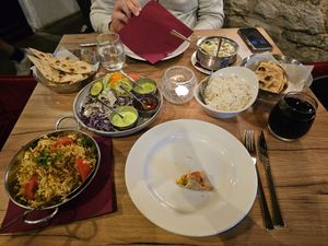 From left to right: Vegetarian naan, biryani, empty samosa plate, vegetarian curry, rice, paratha at Chakra in Tallinn