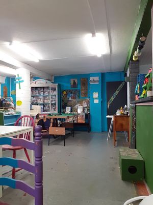 Green counter to place food and drink orders, to the left is the condiment etc table. at Doncaster Skate Co-operative in Doncaster