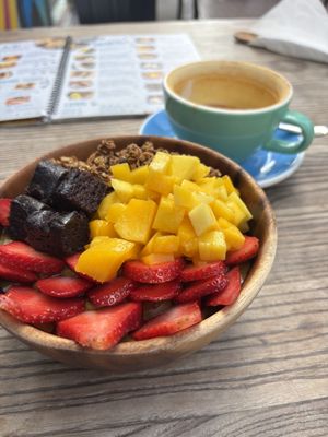 Acai bowl with brownie pieces, granola, mango and strawberries, with turmeric latte  #Veganuary at Projeto Acai - Dubai Marina in Dubai