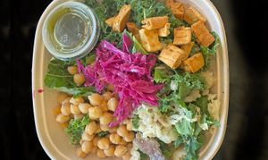 Healthy kale meets Bombay street food in a tangy, crunchy, spicy salad.  
With chickpeas, kale, chaat potato, naan crisps, and green chutney dressing. at Ruta's Fresh Indian Fare in Milwaukee