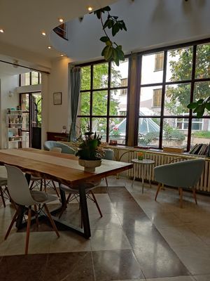 Inside with a view of the garden at The Light - Tea House in Prague